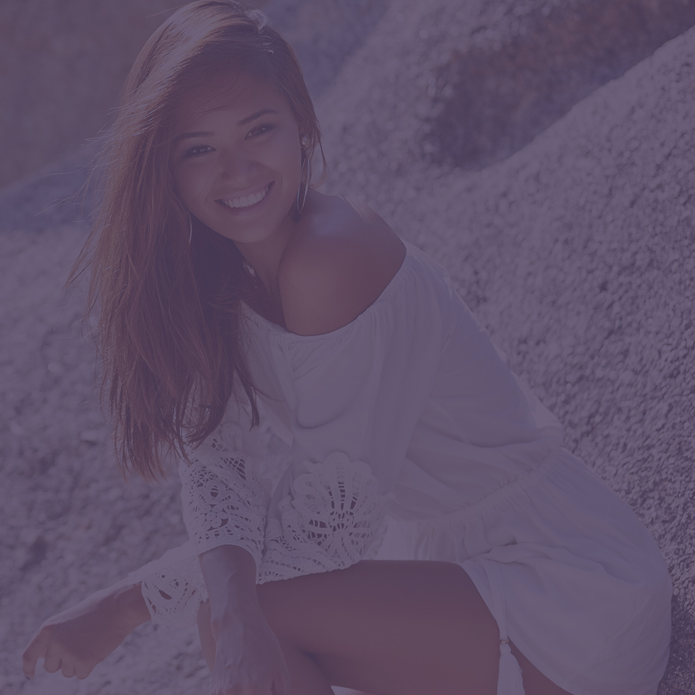 Cute pretty tanned slim girl in white dress on the beach