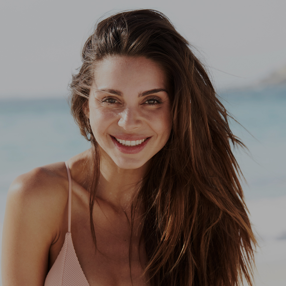 Brunette bikini babe smiling on beach