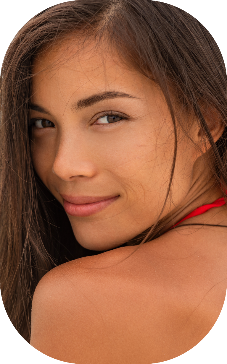 Smiling young woman happy relaxing on beach holidays. Beauty model portrait healthy lifestyle young chinese caucasian girl in her 20s.