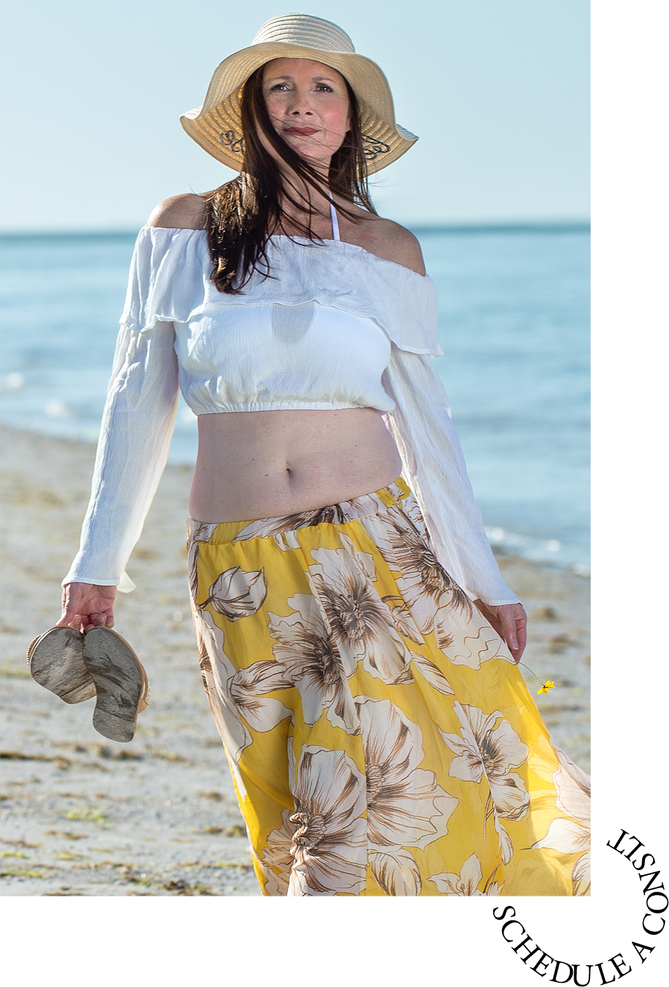 Middle age woman over 50 in yellow skirt with long hair walking alone on a Florida beach