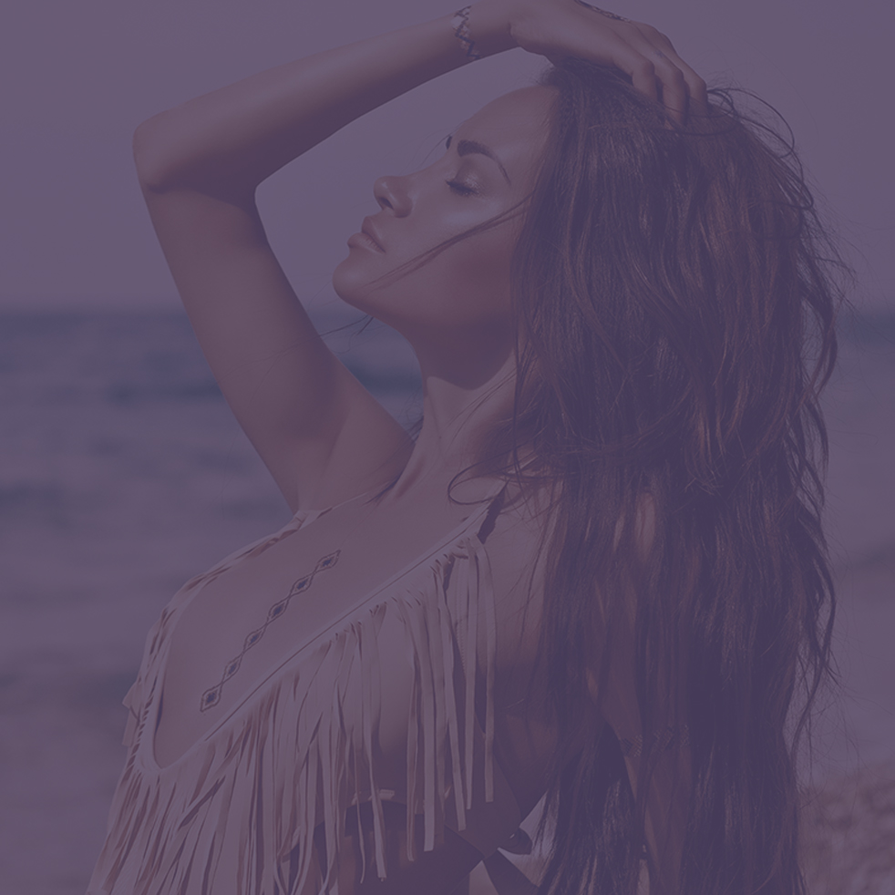 woman laying on beach gazing up into sky