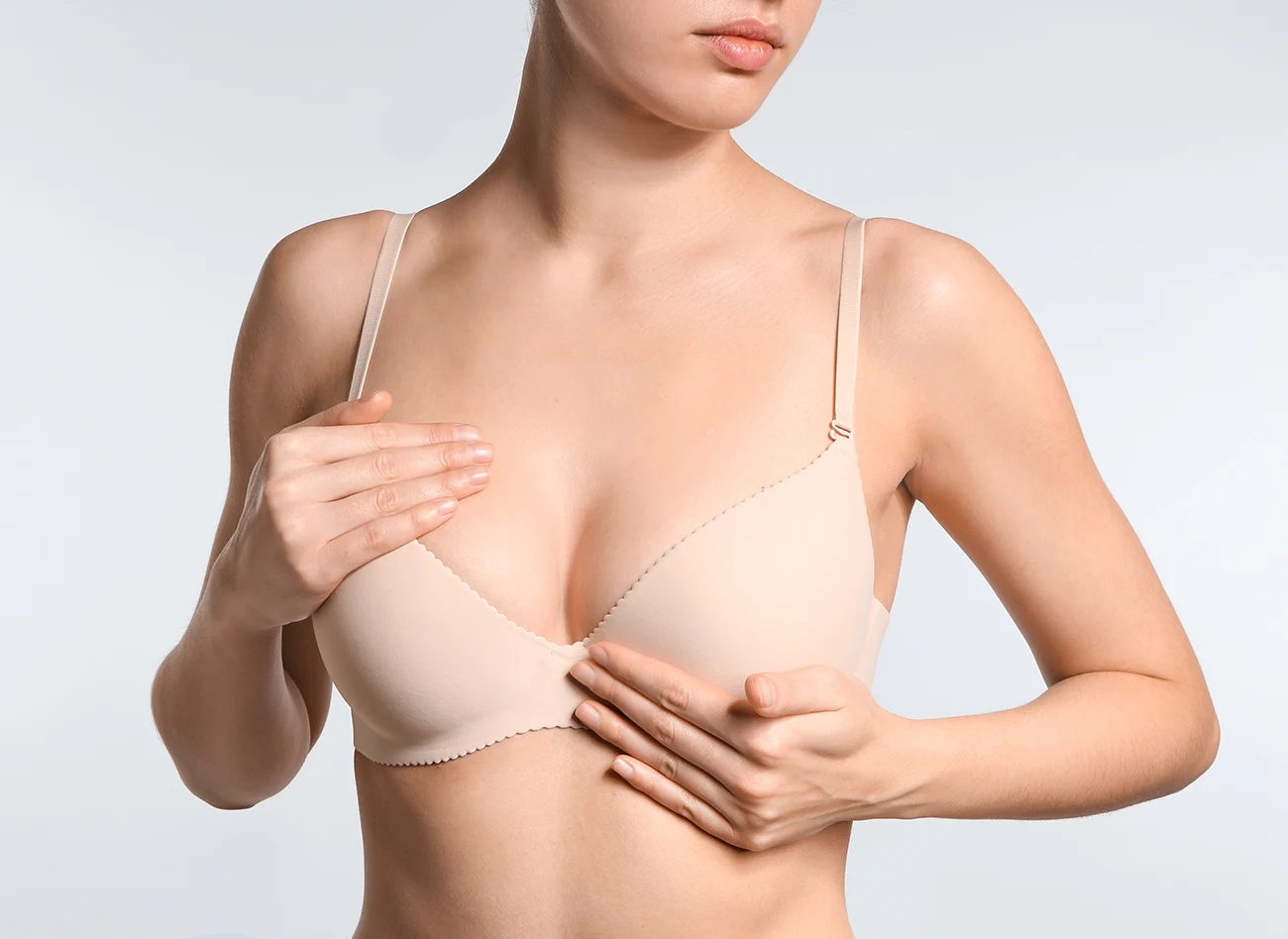 Woman performing breast self-exam.